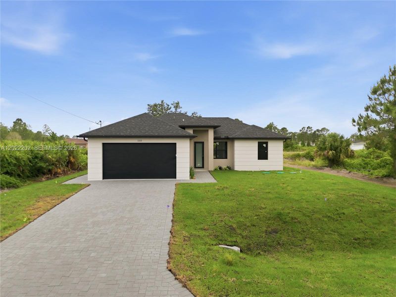 Front exterior of a new home in , Lehigh Acres, FL, highlighting curb appeal (Image 19).