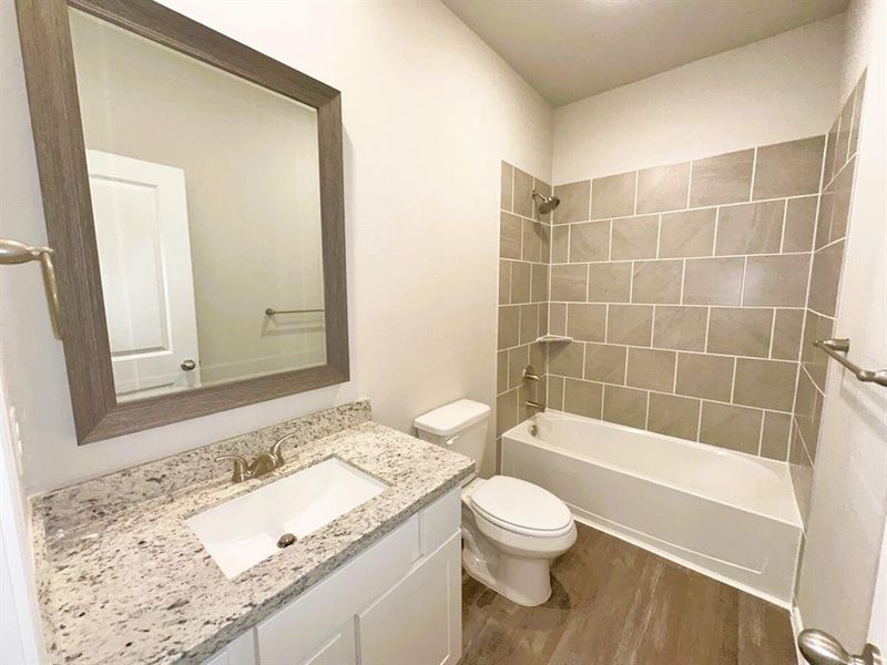 Bath 2 includes granite counters, framed mirror & ceramic tile tub/shower walls