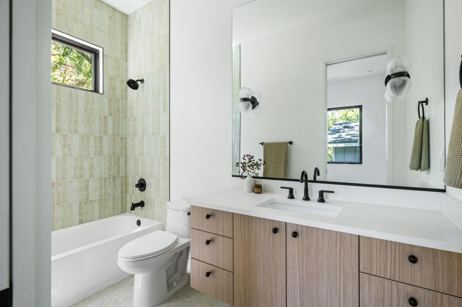 Clean lines and vertical tile detailing create a serene, contemporary bathroom space.