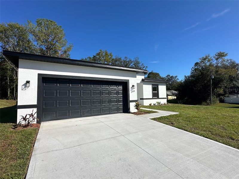 Front exterior of a new home in , Citrus Springs, FL, highlighting curb appeal (Image 2).
