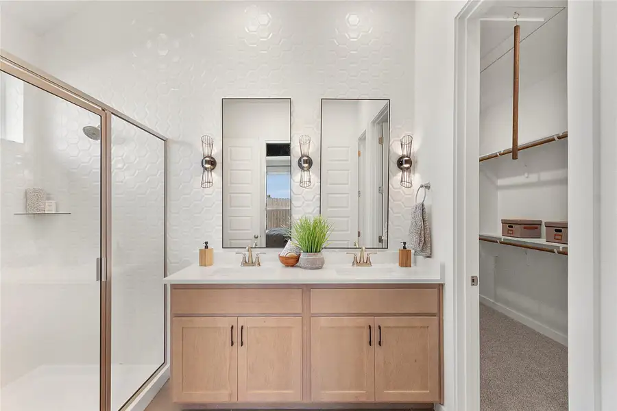 Ensuite bathroom with **PHOTO IS REPRESENTATIVE OF FLOORPLAN ONLY**a stall shower, double vanity, and a spacious closet