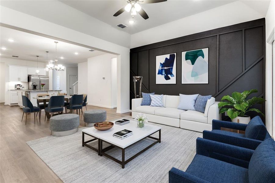 Virtually stage - Living room featuring light hardwood / wood-style flooring and ceiling fan with notable chandelier