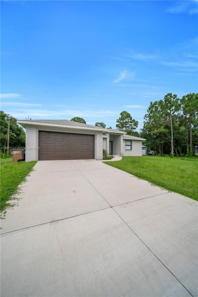 Front exterior of a new home in , Lehigh Acres, FL, highlighting curb appeal (Image 22). Front exterior of a new home in , Lehigh Acres, FL, highlighting curb appeal (Image 22).
