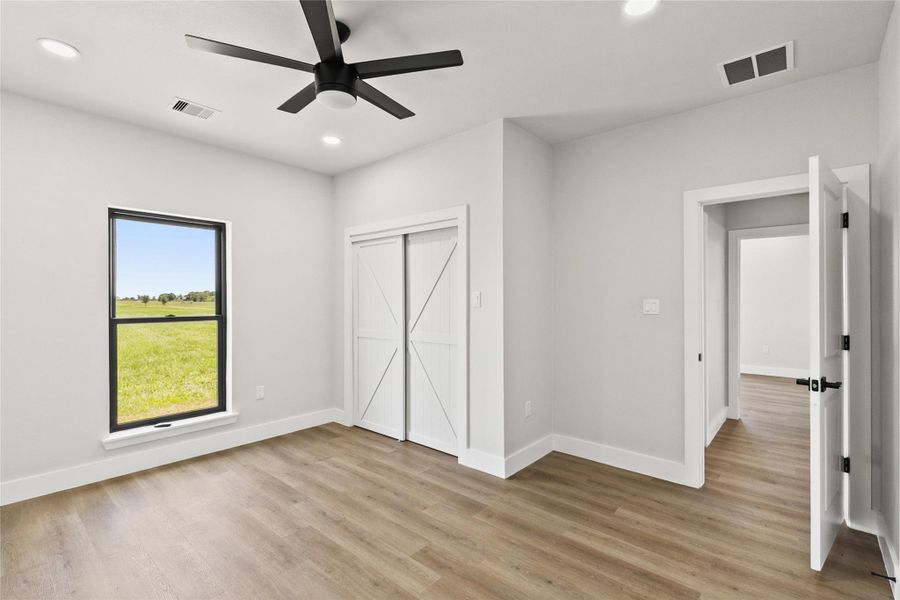 Secondary bedroom with a closet and convenient access to the full guest bathroom. Natural light and neutral finishes provide a comfortable space for guests, family, or a home office.