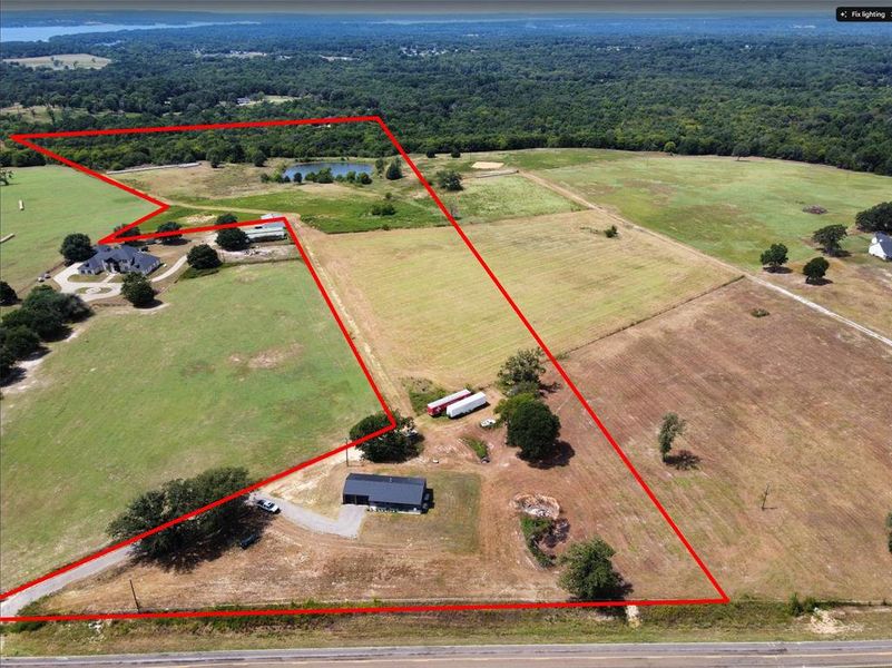 Overview of rural landscape with property parcel outlined and a heavily wooded area Overview of rural landscape with property parcel outlined and a heavily wooded area