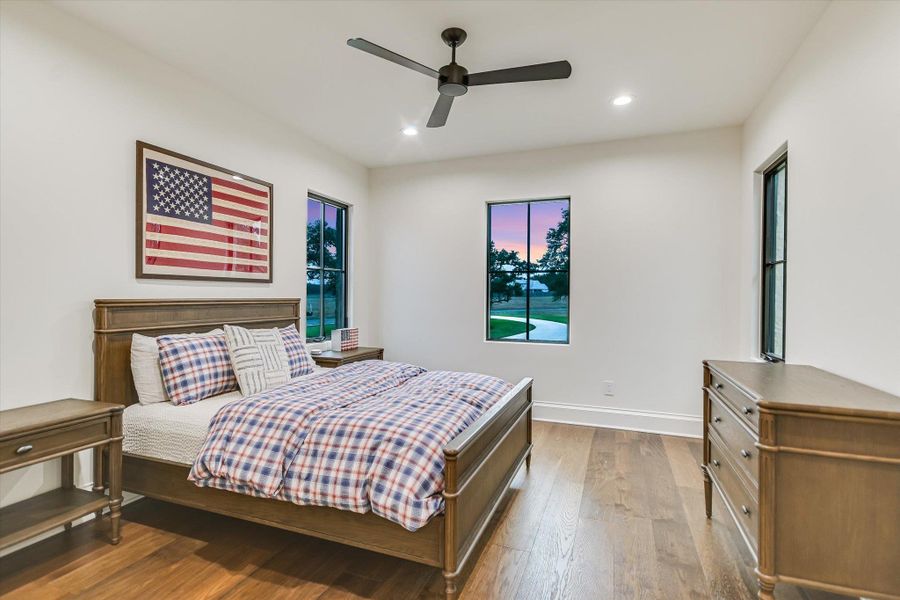Bedroom featuring wood-type flooring, ceiling fan, and recessed lighting Bedroom featuring wood-type flooring, ceiling fan, and recessed lighting