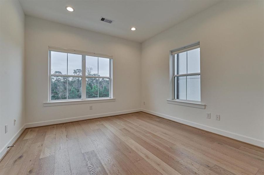 Secondary bedroom with expansive windows overlooking the rear nature views!