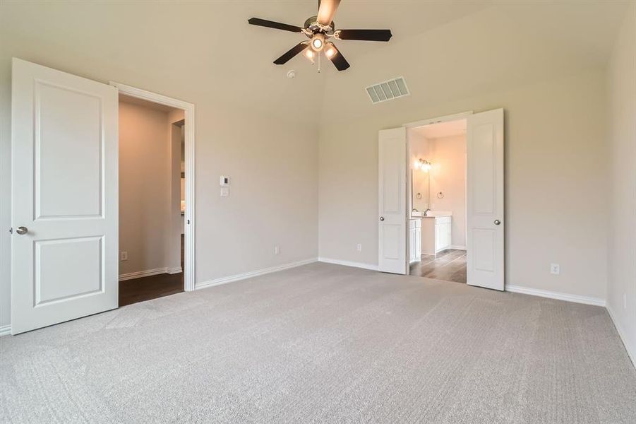 Unfurnished bedroom with ceiling fan, high vaulted ceiling, and carpet