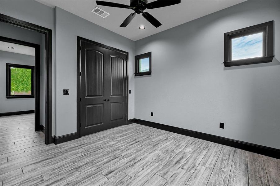 Unfurnished bedroom with light wood finished floors, baseboards, a closet, and a ceiling fan Unfurnished bedroom with light wood finished floors, baseboards, a closet, and a ceiling fan