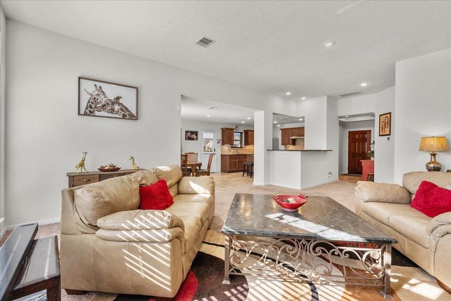 The living room features a cozy fireplace and is bathed in natural morning light through an abundance of windows The living room features a cozy fireplace and is bathed in natural morning light through an abundance of windows