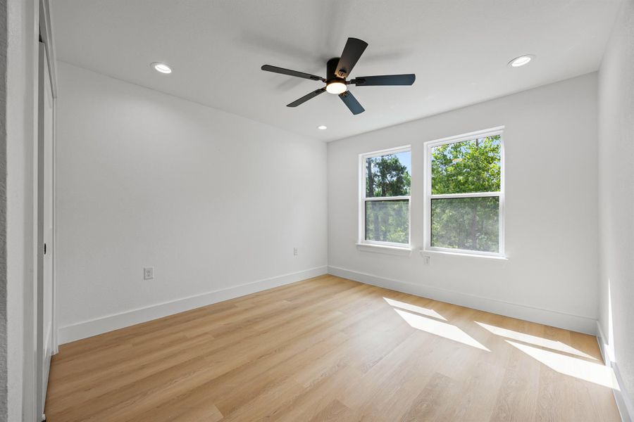 Spare room with light wood finished floors, recessed lighting, and ceiling fan Spare room with light wood finished floors, recessed lighting, and ceiling fan