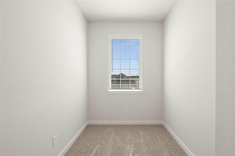 A well-lit small room offers a versatile space, perfect for an office or cozy nook.