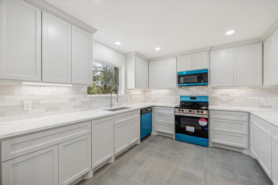 Kitchen with plenty of storage,  stainless steel appliances, undermount cabinet lights, and included refrigerator!