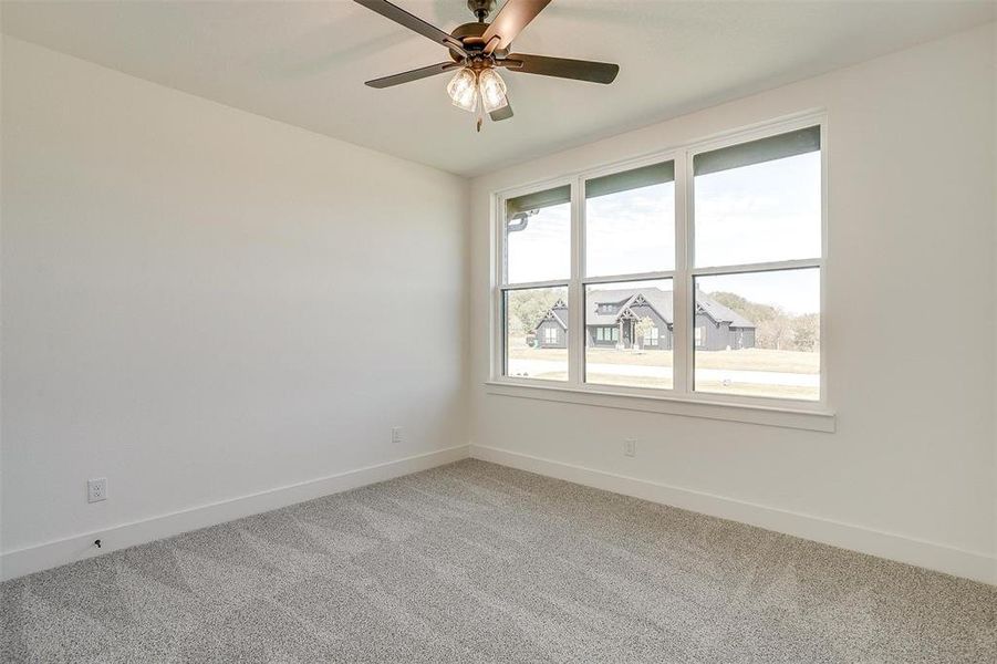 Empty room with carpet and ceiling fan