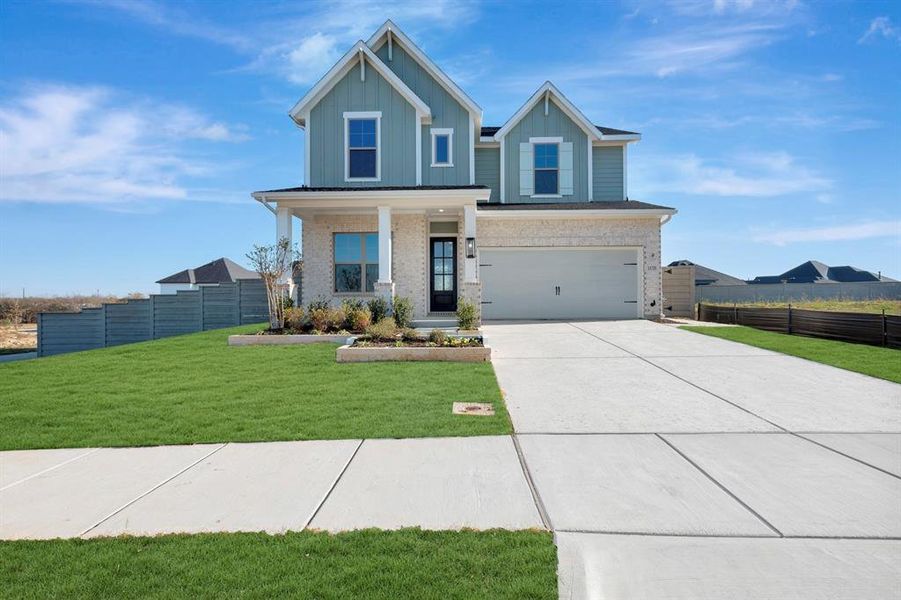 Front exterior of a new home in Treeline, Justin, TX, highlighting curb appeal (Image 1).