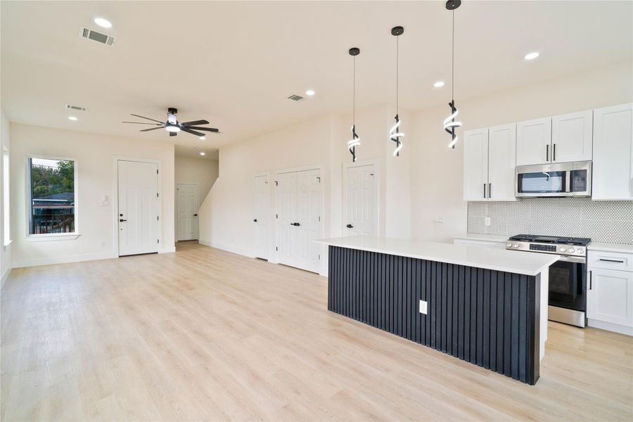 Open floor plan a well sized island and tons of natural light make this space perfect for entertaining