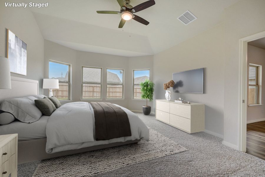 Virtually staged primary suite bedroom in the Pearl floorplan at a Meritage Homes community.