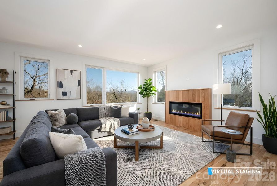 Spacious Living Room with Oversized Windows Framing Winter Mountain Views (Virtually Staged)