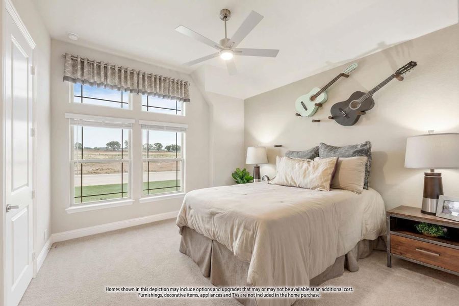 Bedroom with vaulted ceiling, ceiling fan, carpet flooring, and large windows overlooking open land Bedroom with vaulted ceiling, ceiling fan, carpet flooring, and large windows overlooking open land