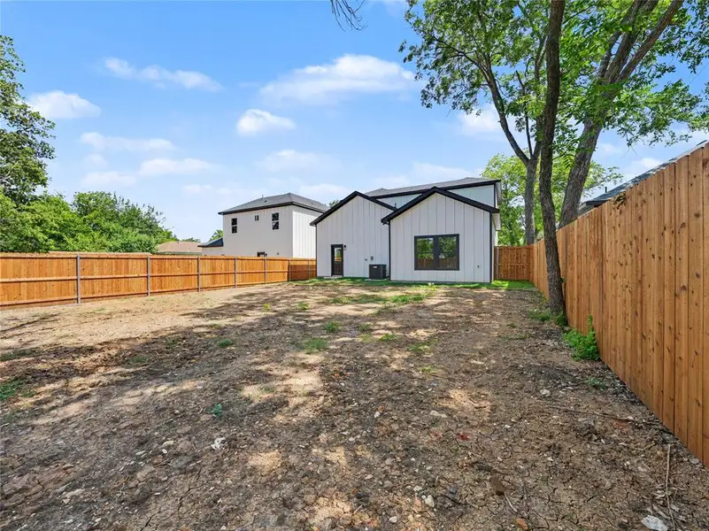 Expansive backyard with wood fencing and mature trees Expansive backyard with wood fencing and mature trees