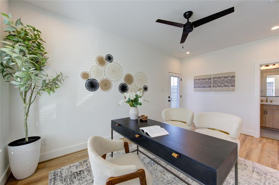 1st Floor Bedroom staged as a home office. Lots of natural light and a door leading to a fenced in backyard.