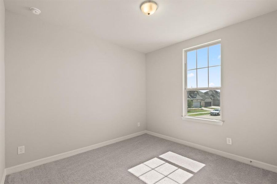 Your secondary bedroom features plush carpet, fresh paint, closet, and a large window that lets in plenty of natural lighting.