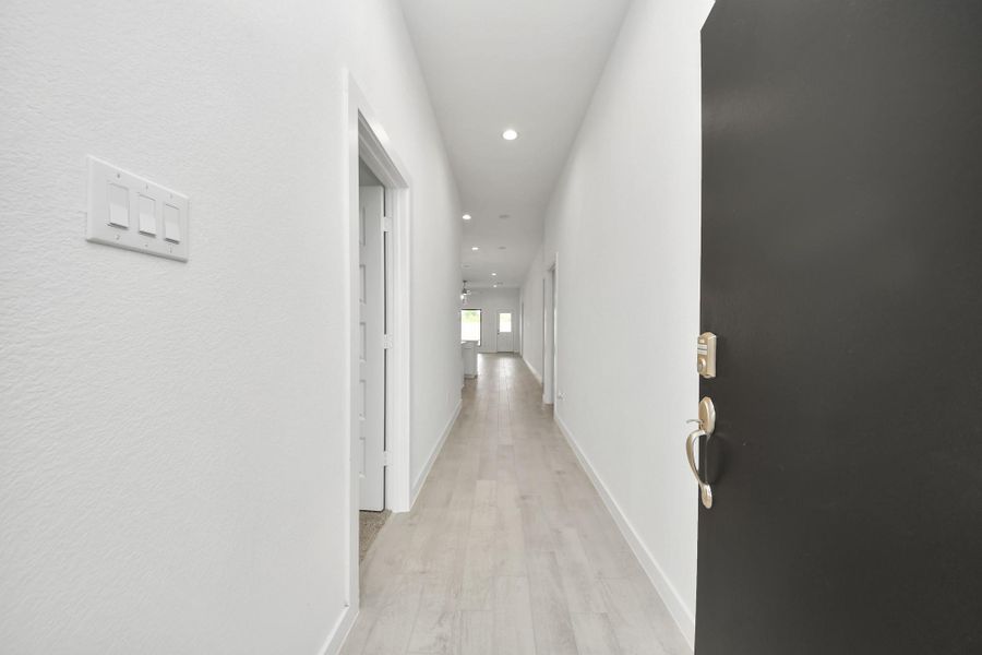 As you step into the threshold of this luxurious home, you'll soon be welcomed by an elegant glass door (to be installed). Inside, soaring ceilings amplify the spaciousness, while the refined wood-look tile flooring and oversized baseboards exude sophistication and charm. Sample photo of completed home with similar floor plan. Actual colors and selections may vary. As you step into the threshold of this luxurious home, you'll soon be welcomed by an elegant glass door (to be installed). Inside, soaring ceilings amplify the spaciousness, while the refined wood-look tile flooring and oversized baseboards exude sophistication and charm. Sample photo of completed home with similar floor plan. Actual colors and selections may vary.