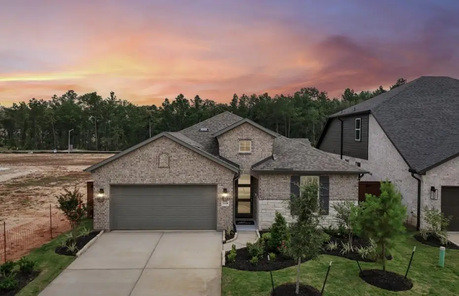 Front exterior of a new home in WILDTREE 50', Montgomery, TX, highlighting curb appeal (Image 1). Front exterior of a new home in WILDTREE 50', Montgomery, TX, highlighting curb appeal (Image 1).
