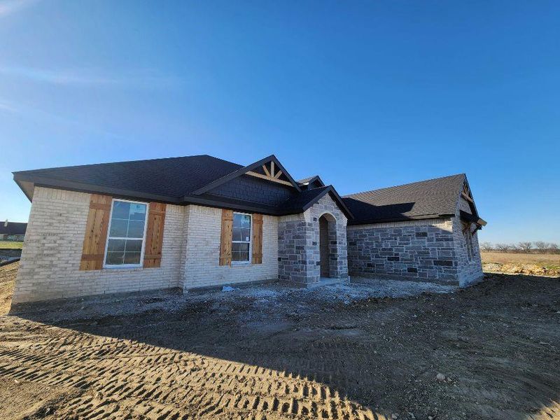 View of front of home with brick siding and stone siding