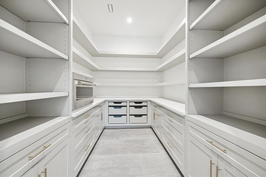 Fitted walk-in pantry with built-in Wolf microwave