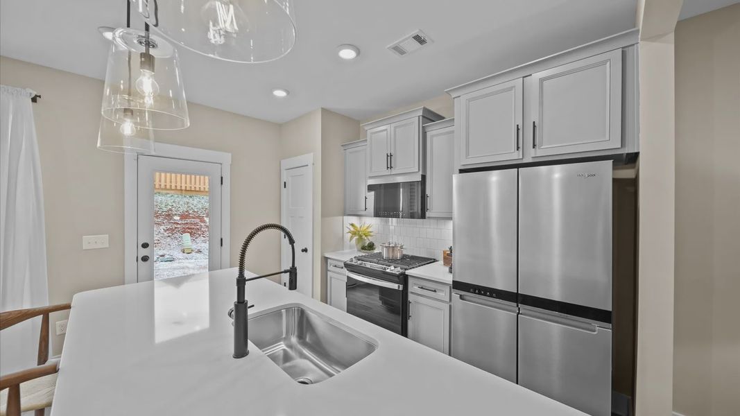 Accomplished layout with a stunning 9-foot island, pendant lighting, and superior craftsmanship