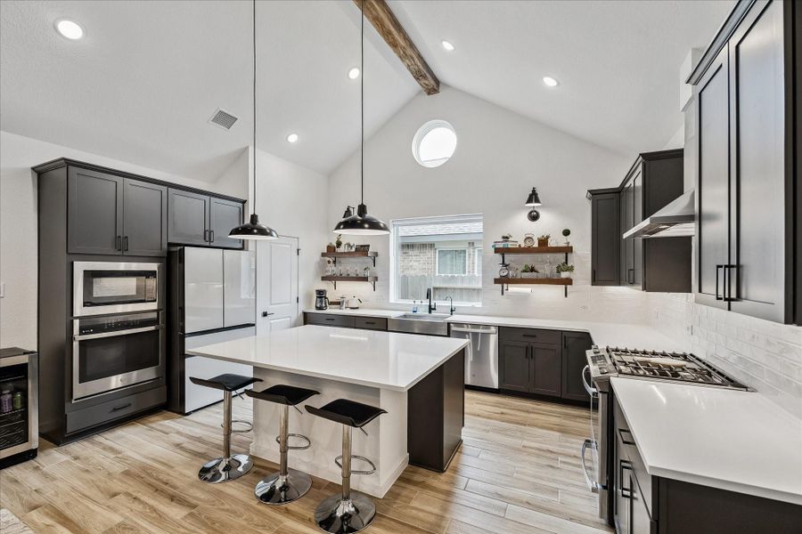Upgraded designer selections throughout include matte black fixtures, recessed lighting, premium plank tile flooring, and modern farmhouse-inspired details.