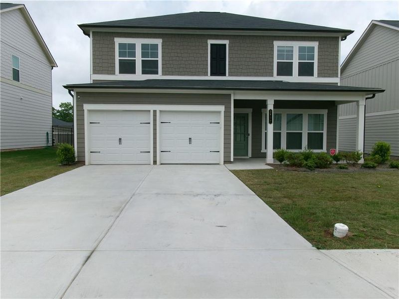 Front exterior of a new home in Alder Park, Conyers, GA, highlighting curb appeal (Image 1).