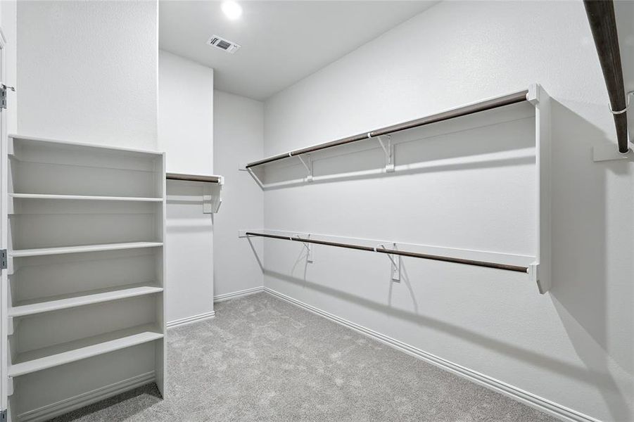 Spacious closet featuring light colored carpet Spacious closet featuring light colored carpet