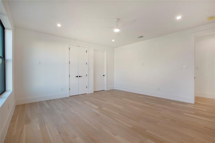 Unfurnished room featuring ceiling fan and light hardwood / wood-style floors