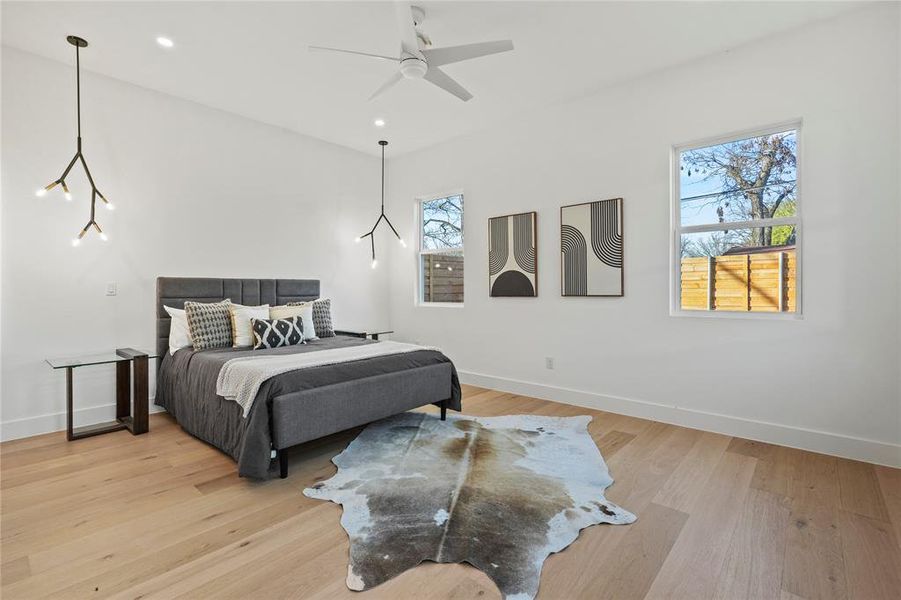 Bedroom featuring light wood finished floors, a ceiling fan, and recessed lighting