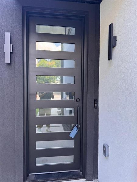 Property entrance featuring stucco siding