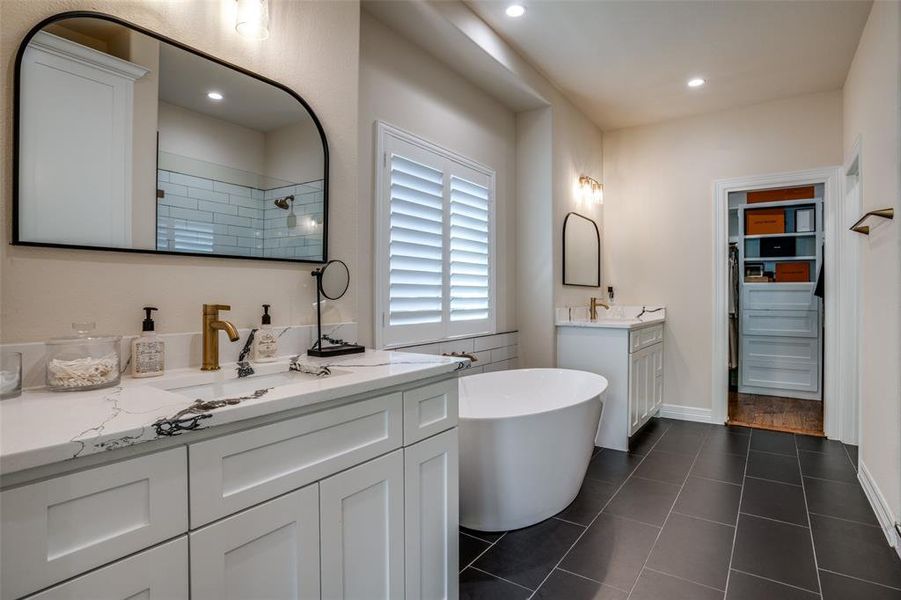 Bathroom featuring vanity, tile patterned floors, and independent shower and bath