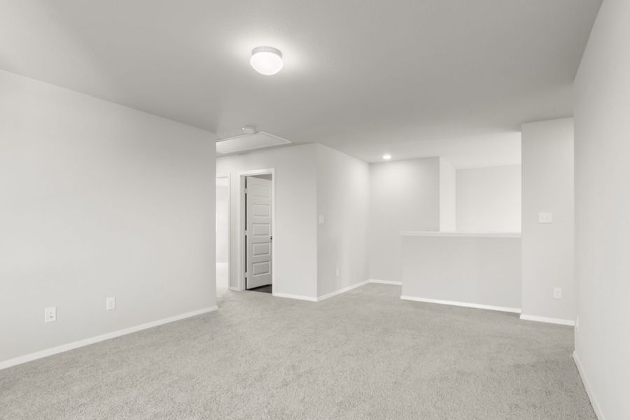 Image of an upstairs flex space with tan carpeting and light grey painted walls Image of an upstairs flex space with tan carpeting and light grey painted walls