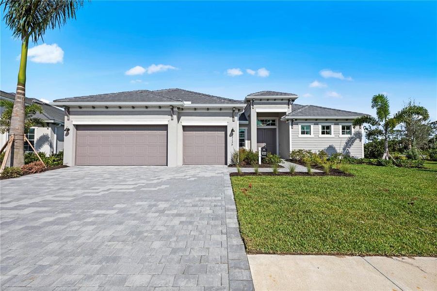 Front exterior of a new home in South Gulf Cove, Port Charlotte, FL, highlighting curb appeal (Image 1).