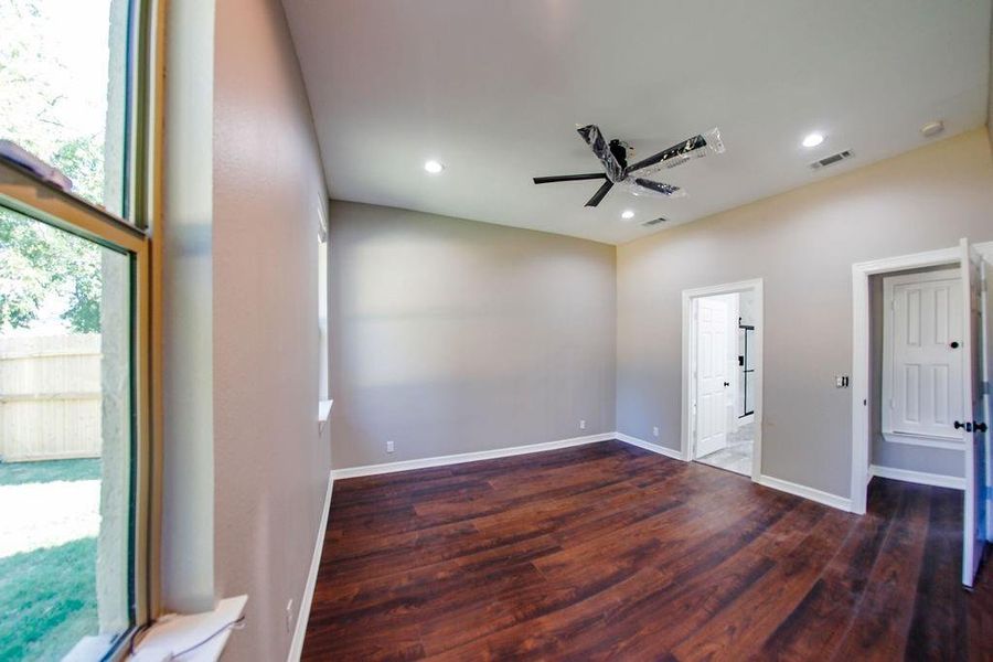 Empty room featuring dark wood-style flooring, a ceiling fan, and recessed lighting Empty room featuring dark wood-style flooring, a ceiling fan, and recessed lighting