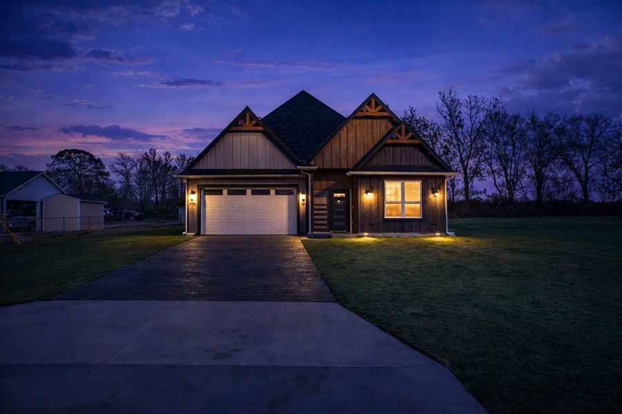 Craftsman inspired home with a yard, driveway, board and batten siding, and a garage Craftsman inspired home with a yard, driveway, board and batten siding, and a garage