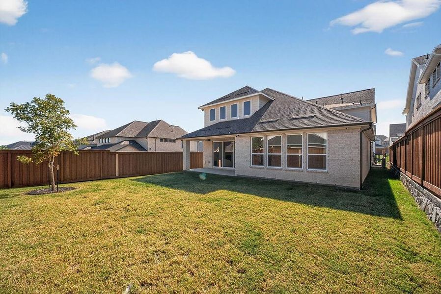 Back of house with brick siding, a patio area, a fenced backyard, and a shingled roof Back of house with brick siding, a patio area, a fenced backyard, and a shingled roof