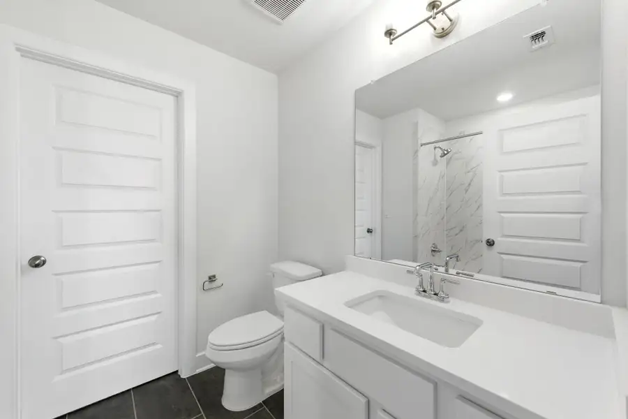Bathroom with a shower, vanity, and tile patterned floors Bathroom with a shower, vanity, and tile patterned floors