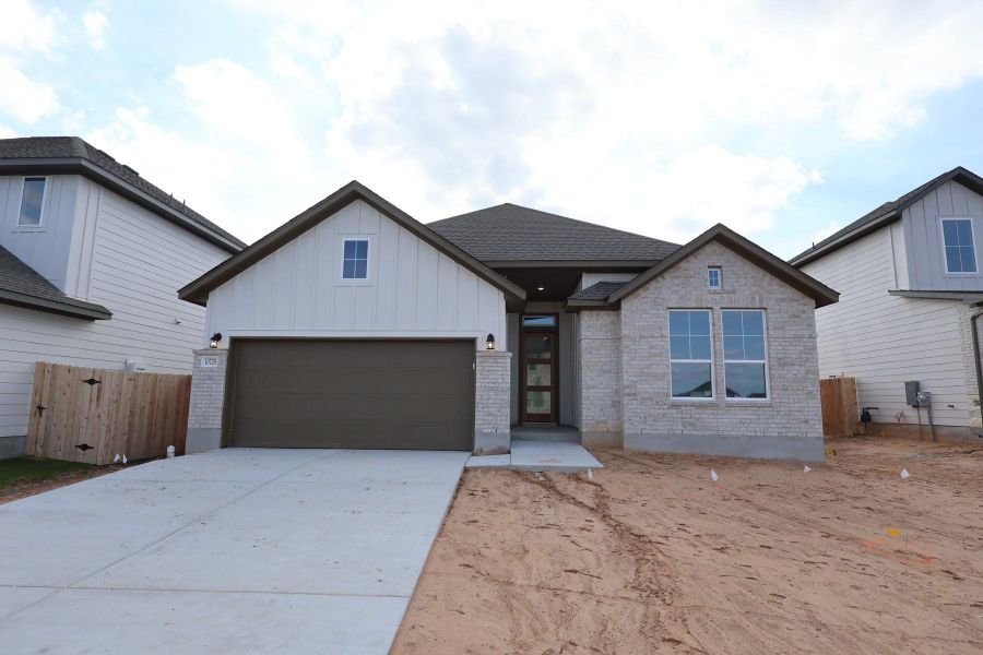 Front exterior of a new home in Lagos Reserve, Manor, TX, highlighting curb appeal (Image 10).