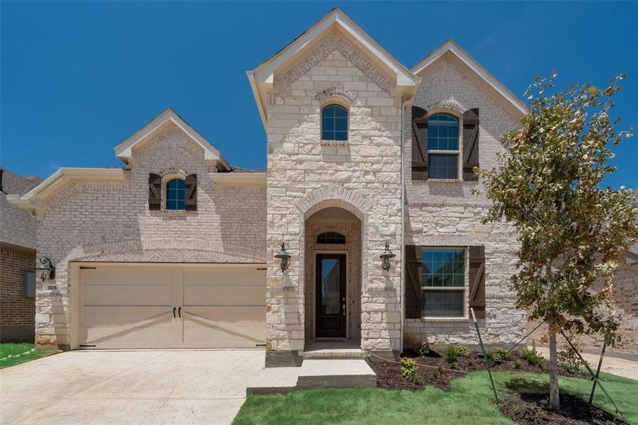 French provincial home with a garage