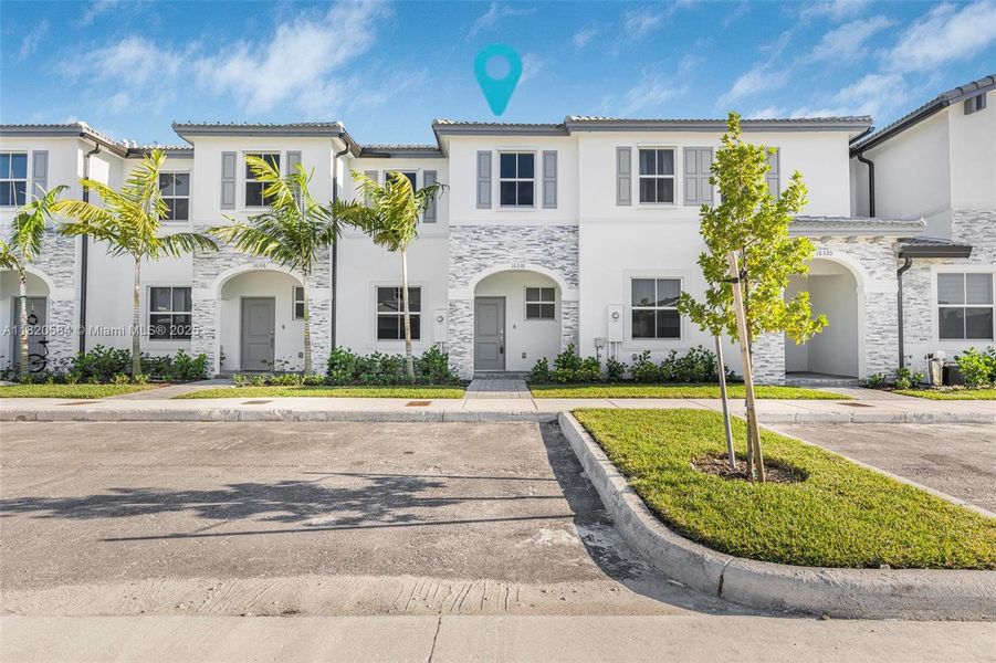 Front exterior of a new home in Cedar Pointe: Cypress Collection, Homestead, FL, highlighting curb appeal (Image 1). Front exterior of a new home in Cedar Pointe: Cypress Collection, Homestead, FL, highlighting curb appeal (Image 1).