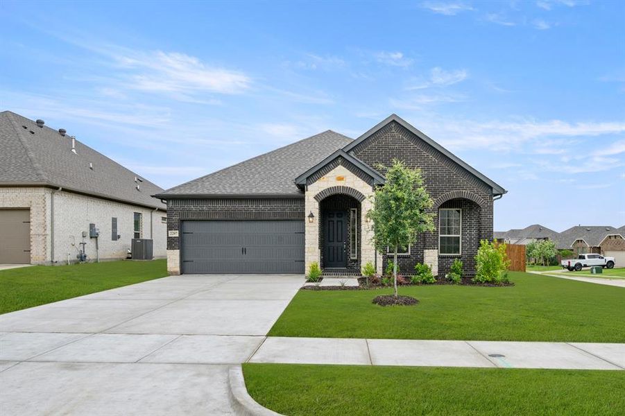 Front exterior of a new home in Sheppard's Place, Waxahachie, TX, highlighting curb appeal (Image 2). Front exterior of a new home in Sheppard's Place, Waxahachie, TX, highlighting curb appeal (Image 2).