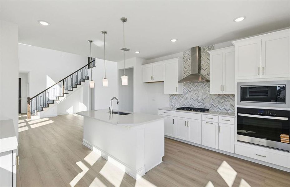 Large island overlooking gathering room and dining areas Large island overlooking gathering room and dining areas