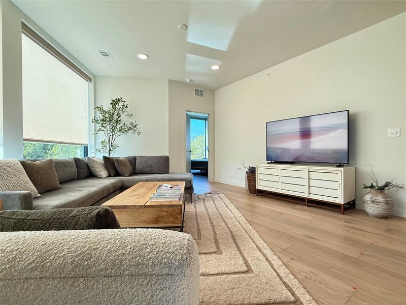 Hardwood floors and generous windows create a light-filled setting for daily living and entertaining.
